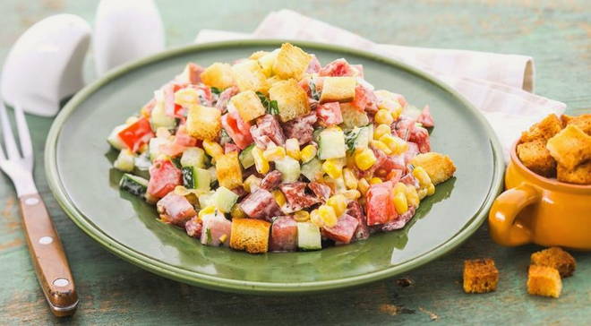 Salate mit Croutons und Würstchen