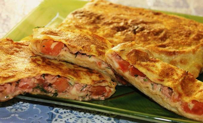 Lavash mit Wurst, Tomate, Käse und Ei in einer Pfanne