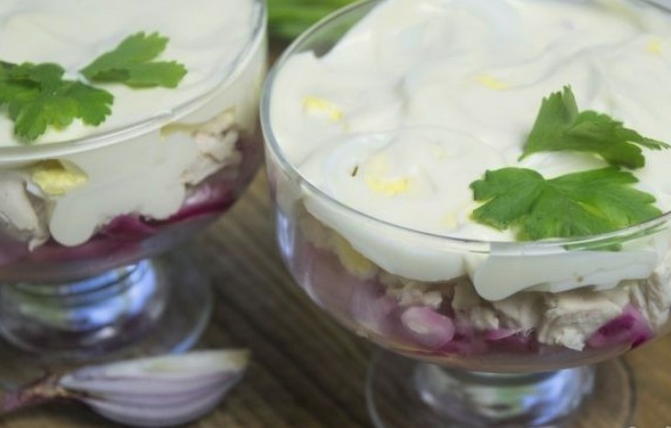 Insalata con pollo, formaggio, uova e cipolle sott'aceto
