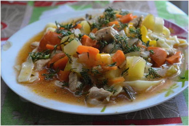 Lagman di maiale con noodles in una pentola a cottura lenta